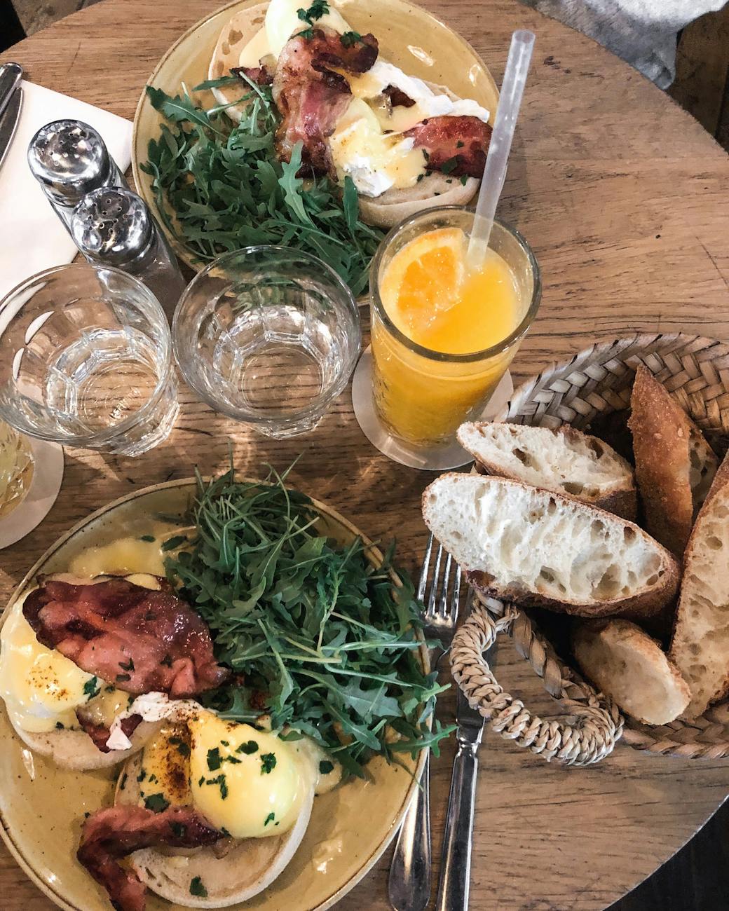 foods and juice served on brown table