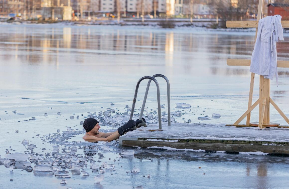 man in frozen lake in winter