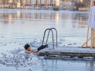 man in frozen lake in winter